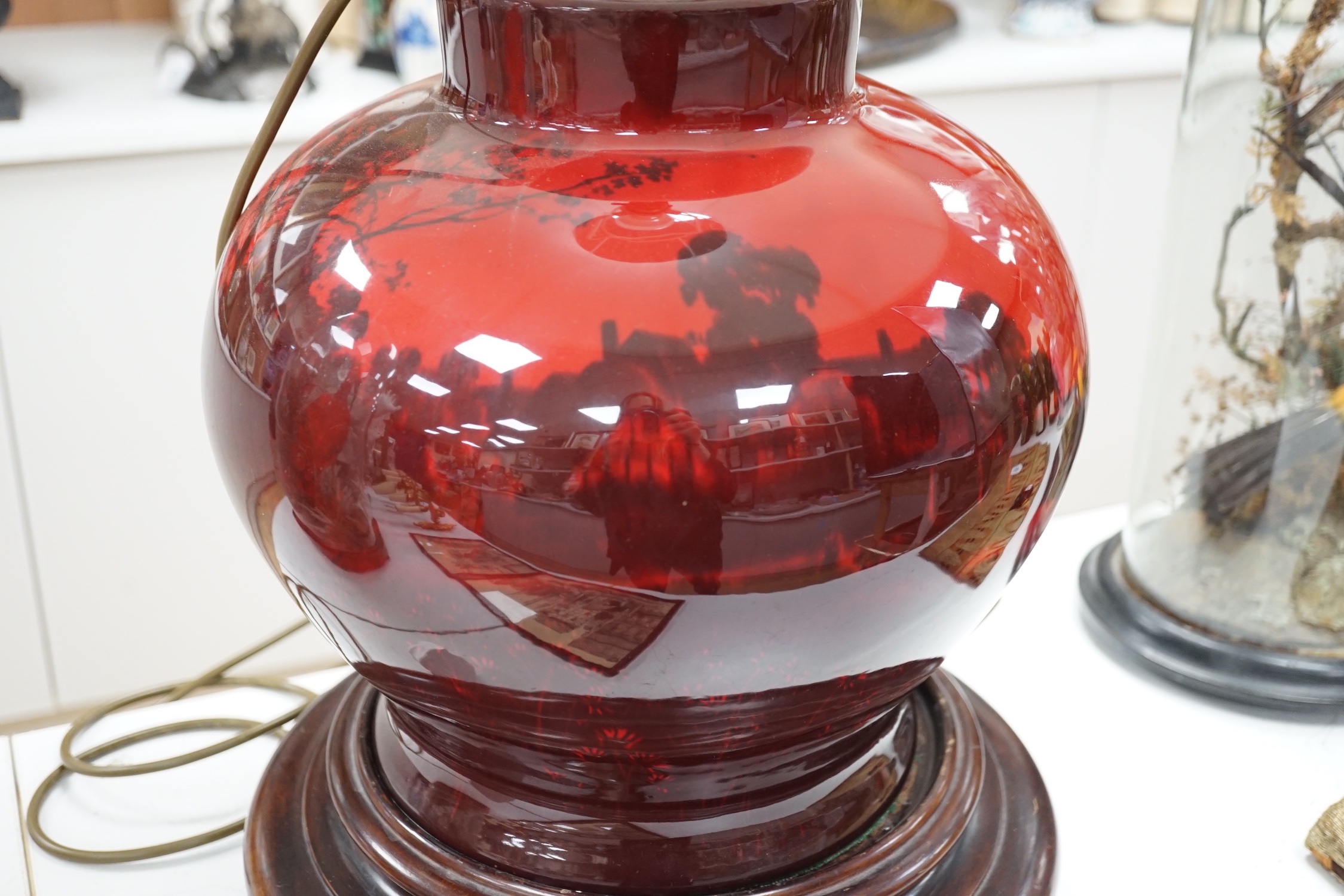 A large Royal Doulton flambe vase, approximately 30.5 cm high excluding all later fittings, mounted as a lamp with shade and associate wood stand.